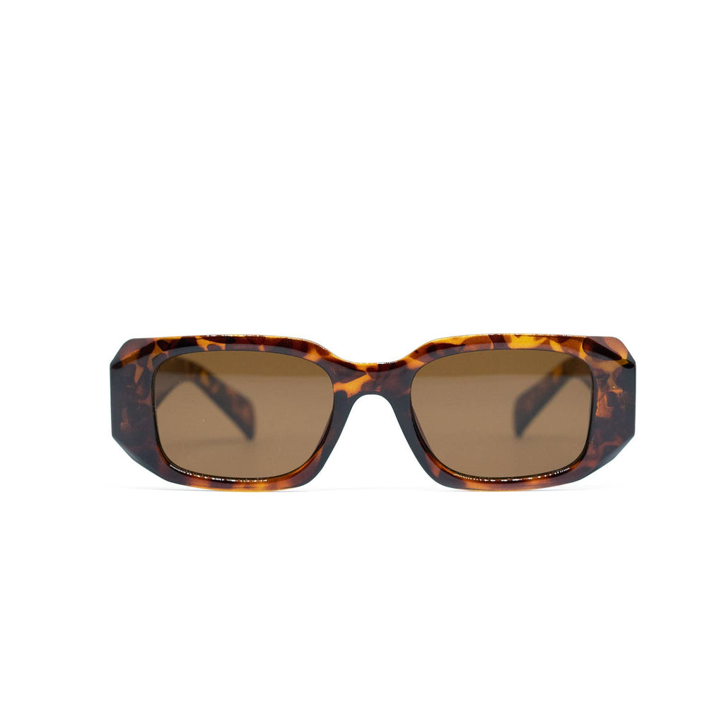 Sunglasses with tortoiseshell frame and brown lenses on a white background