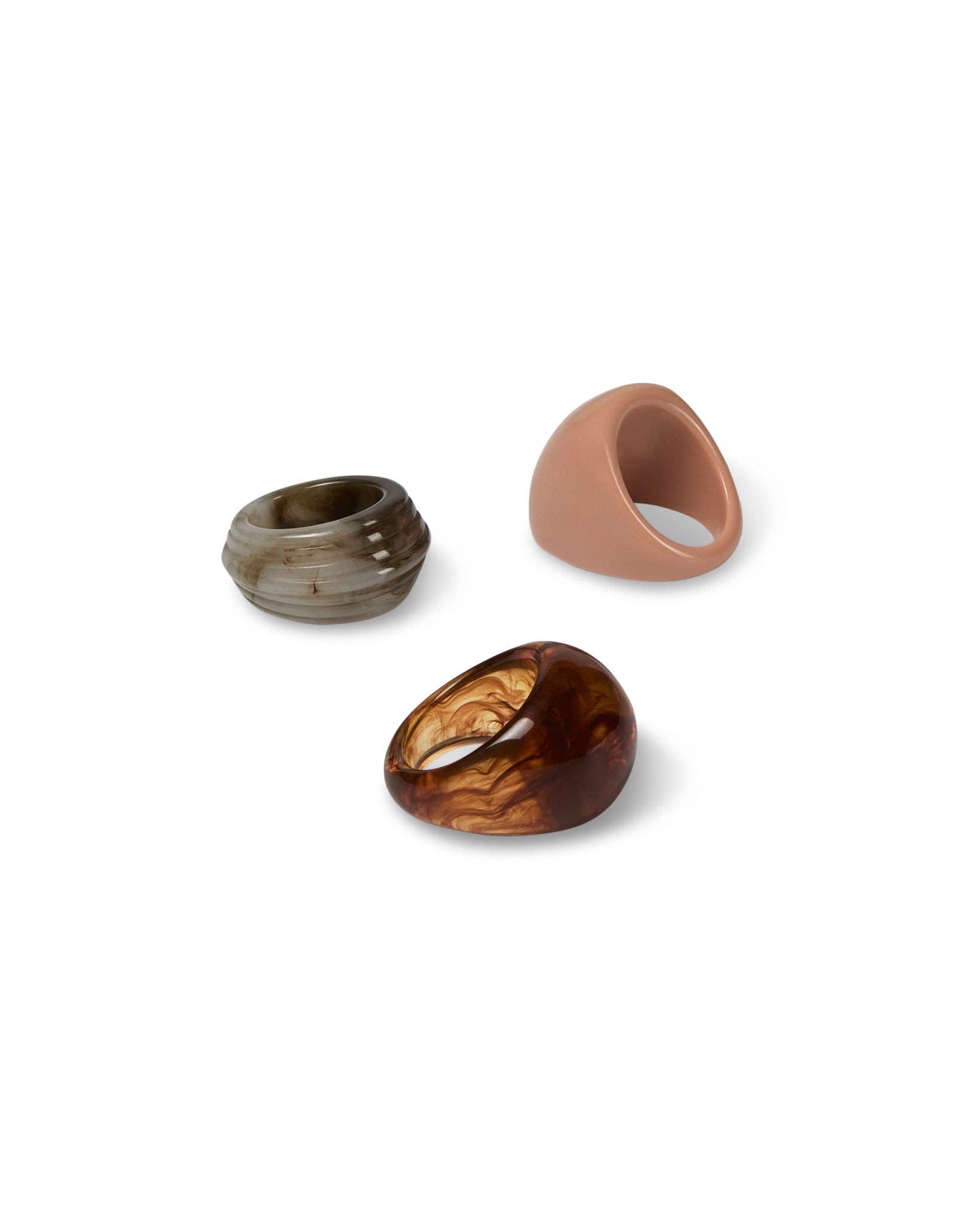 Three  rings with different finishes on a white background