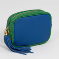 Green and blue pouch with a tassel on a light gray background