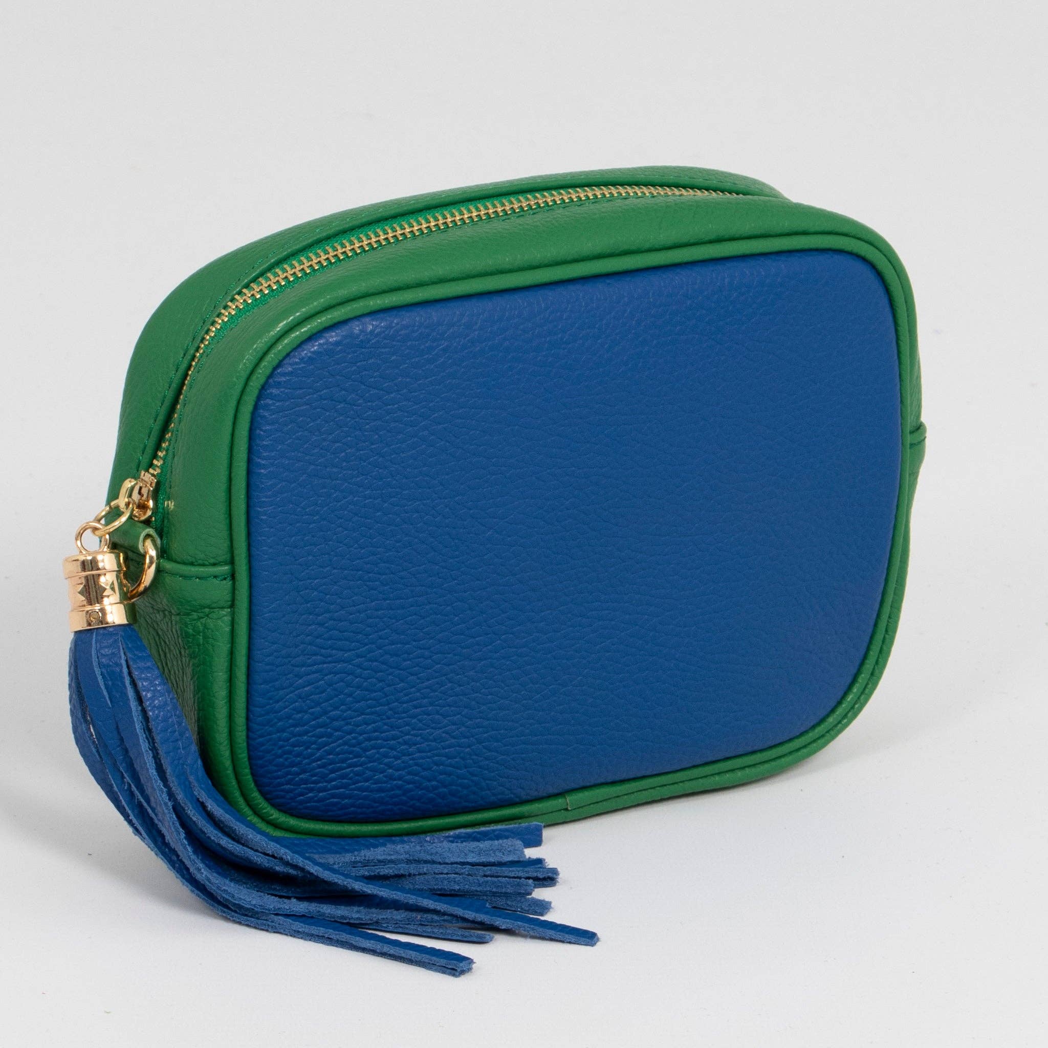 Green and blue pouch with a tassel on a light gray background