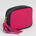 Pink and navy bag with a tassel on a light grey background