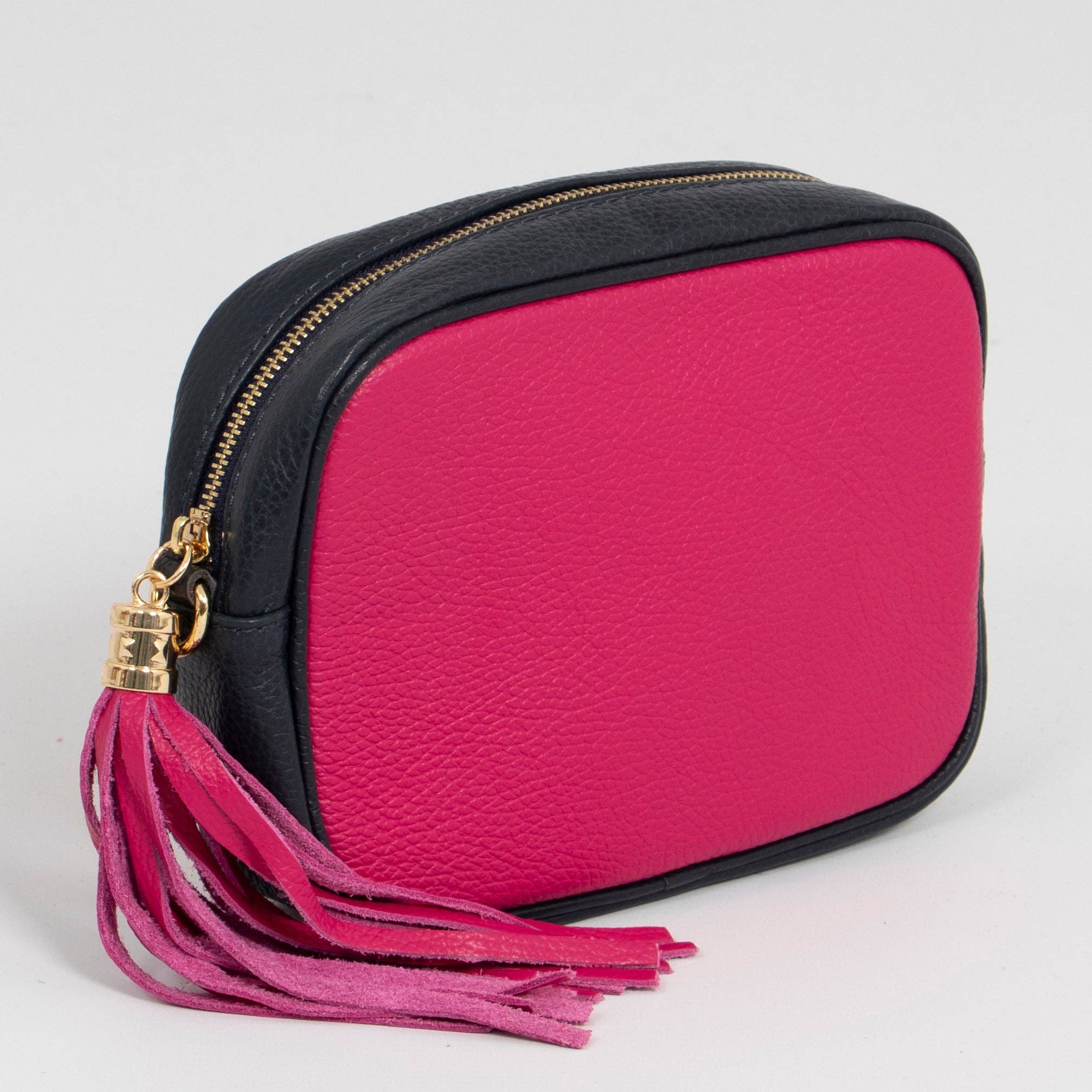 Pink and navy bag with a tassel on a light grey background