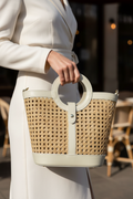 Model holding beige Vienna Straw Tote in hand